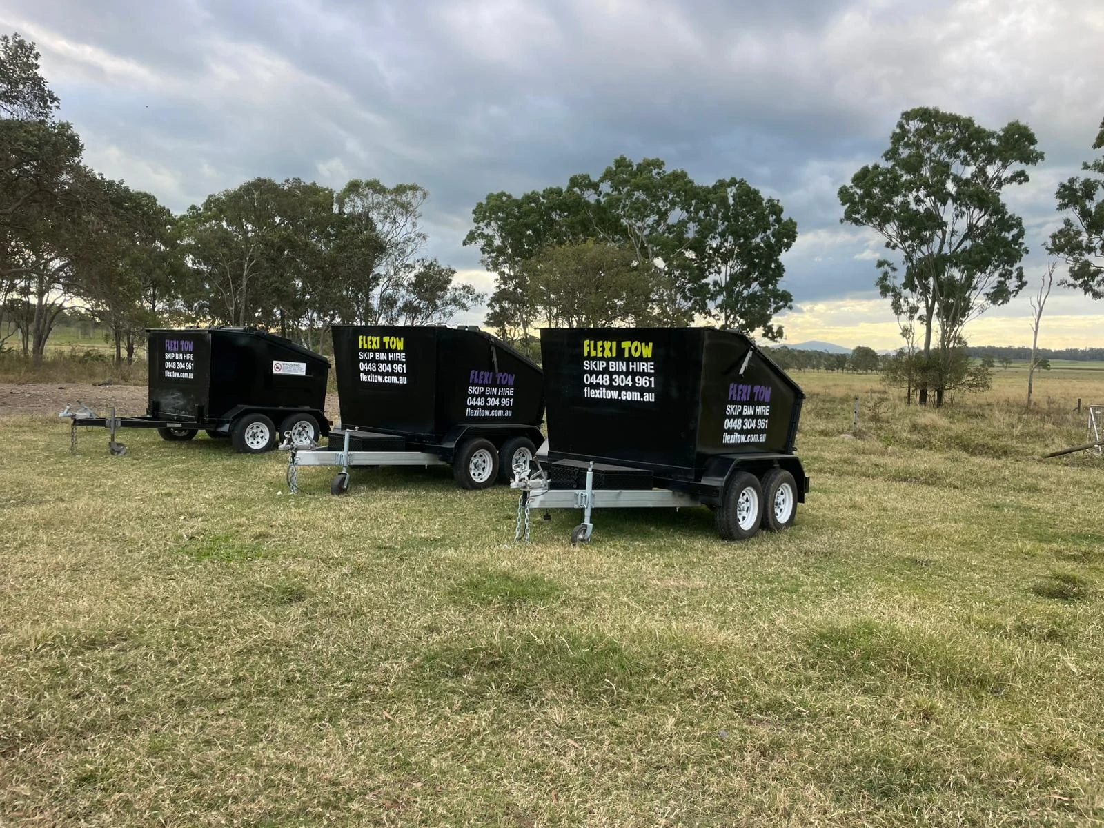 Flexi Tow skip bins parked on property.